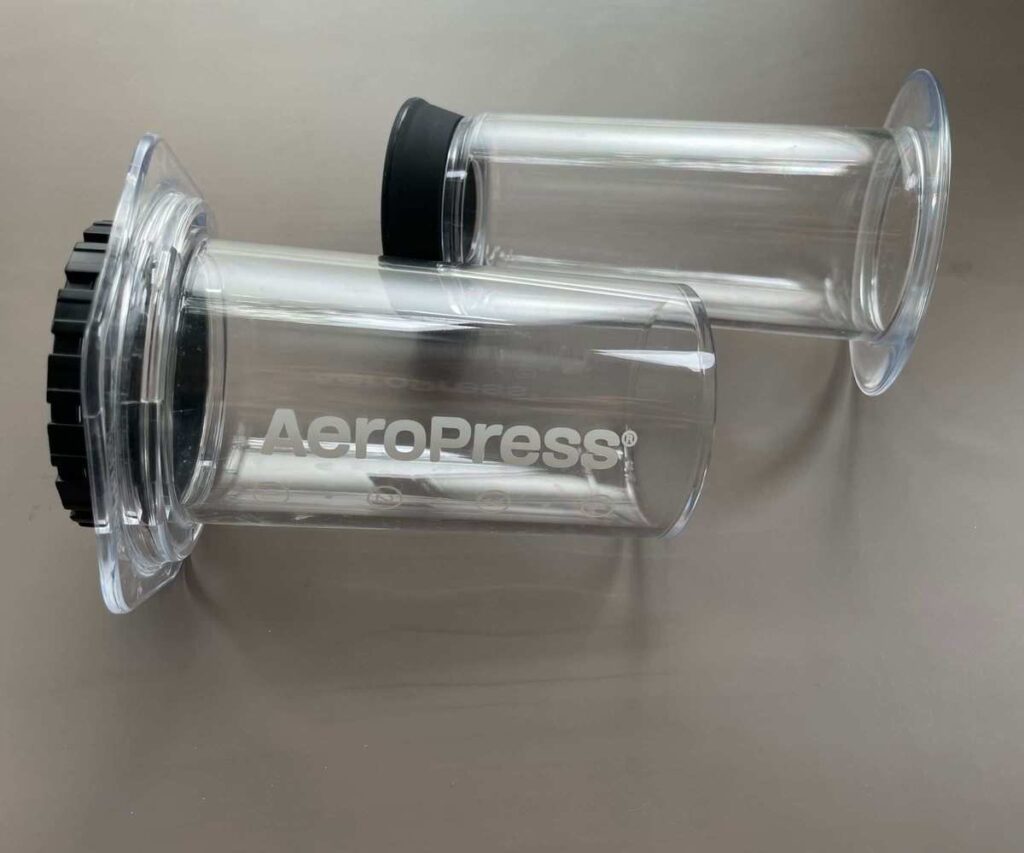 A clear AeroPress in parts on a table, ready to use to make the perfect AeroPress coffee